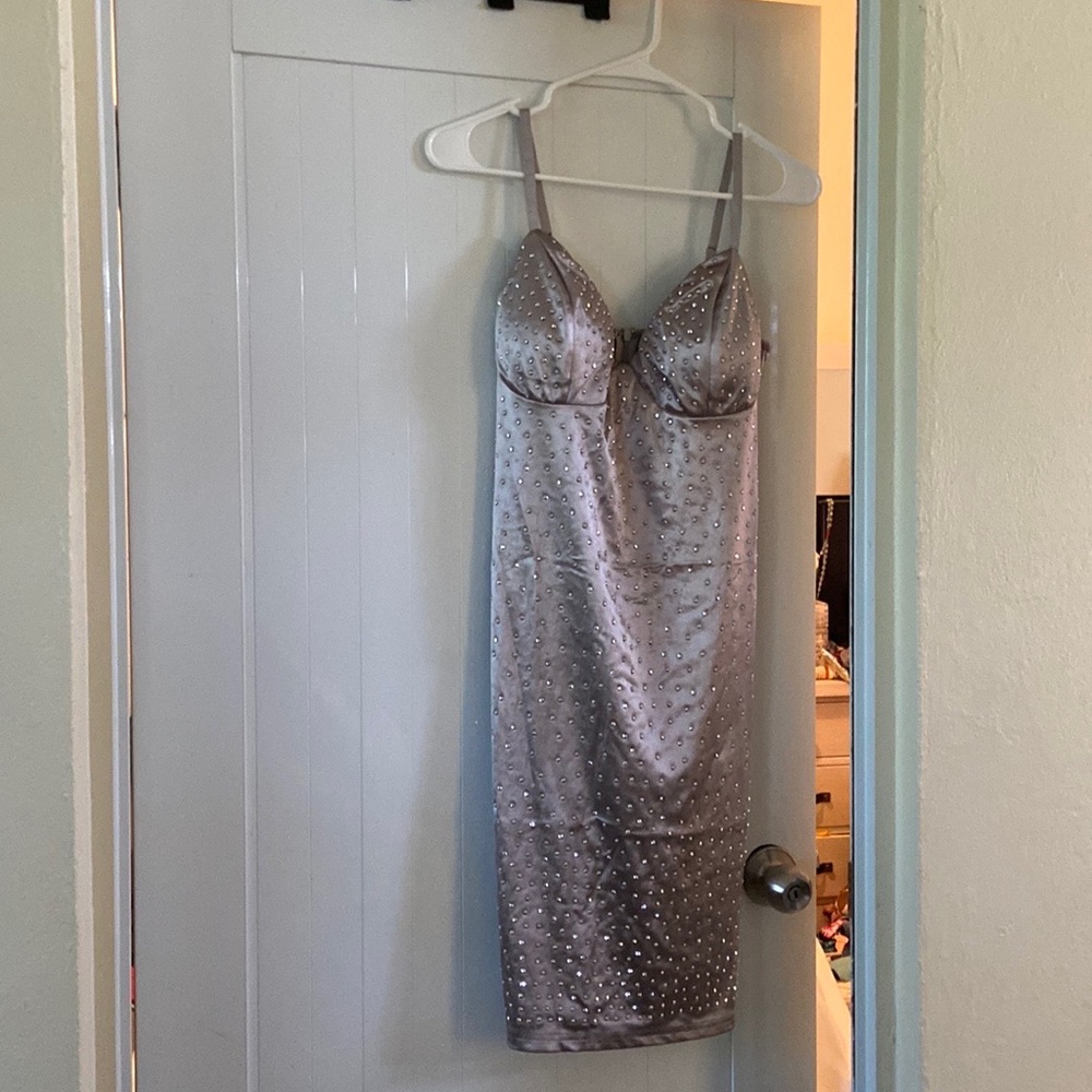 New silver dress with embellishments with tags. Size large.